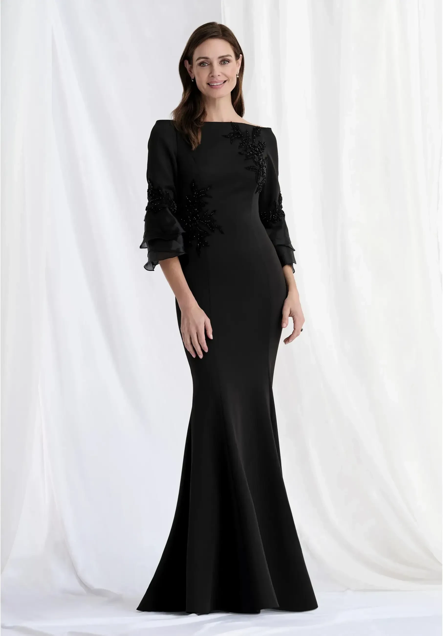 model is wearing a black quarter length sleeve mother of the bride or groom dress