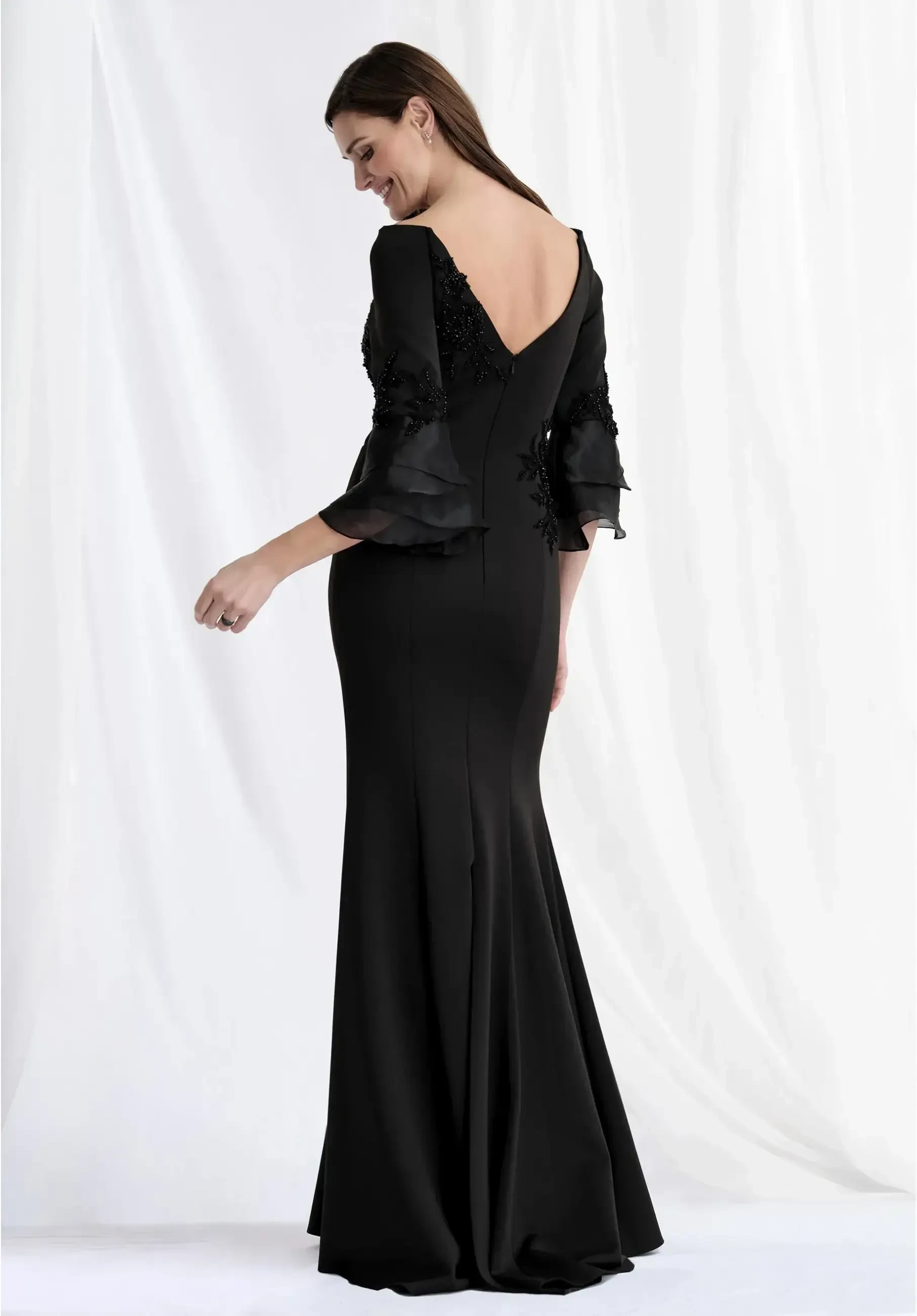 model is wearing a black quarter length sleeve mother of the bride or groom dress
