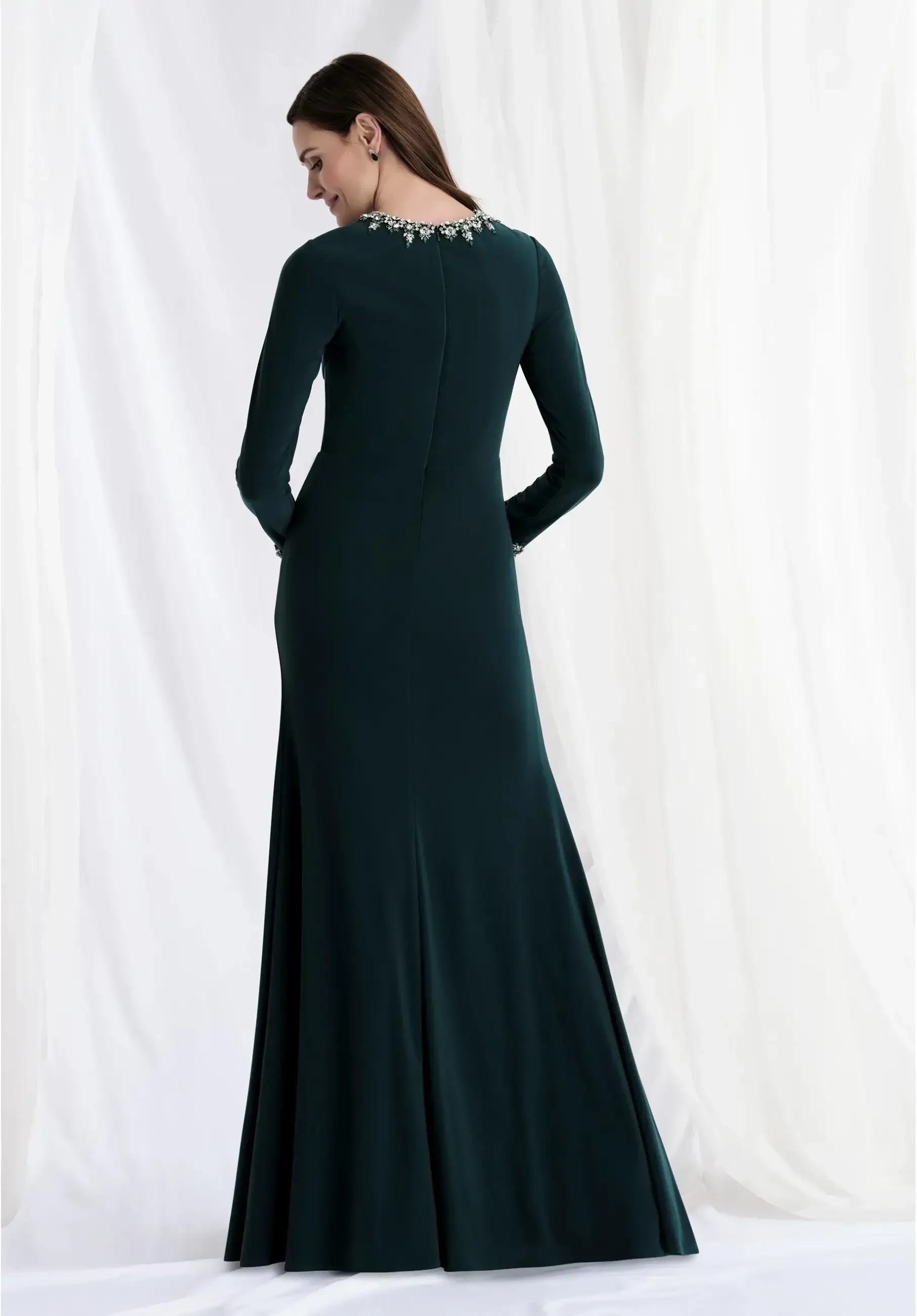 model is wearing a dark green long sleeve scoop neckline mother of the bride dress