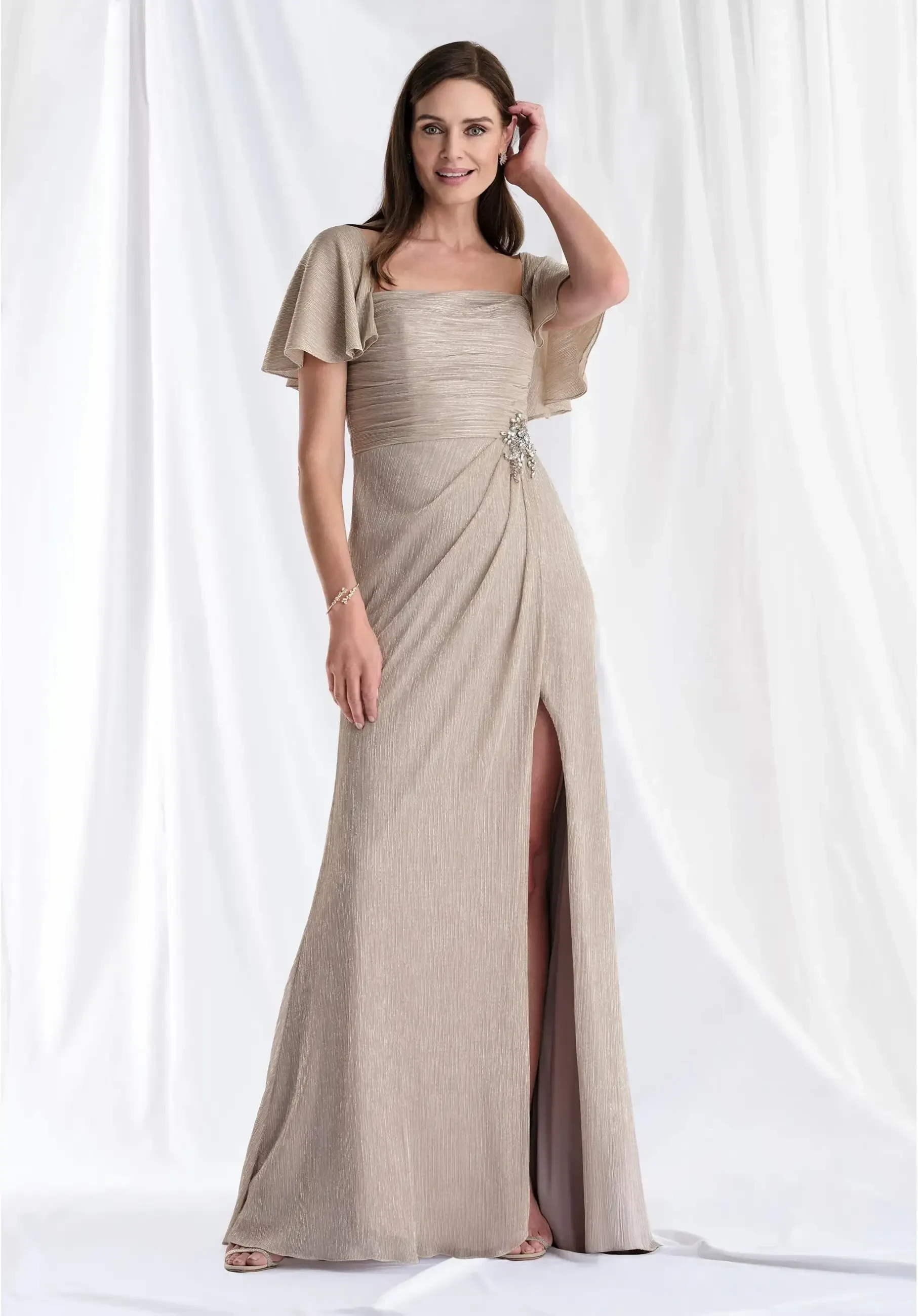 model is wearing a flutter sleeve floor length neutral other of the bride dress