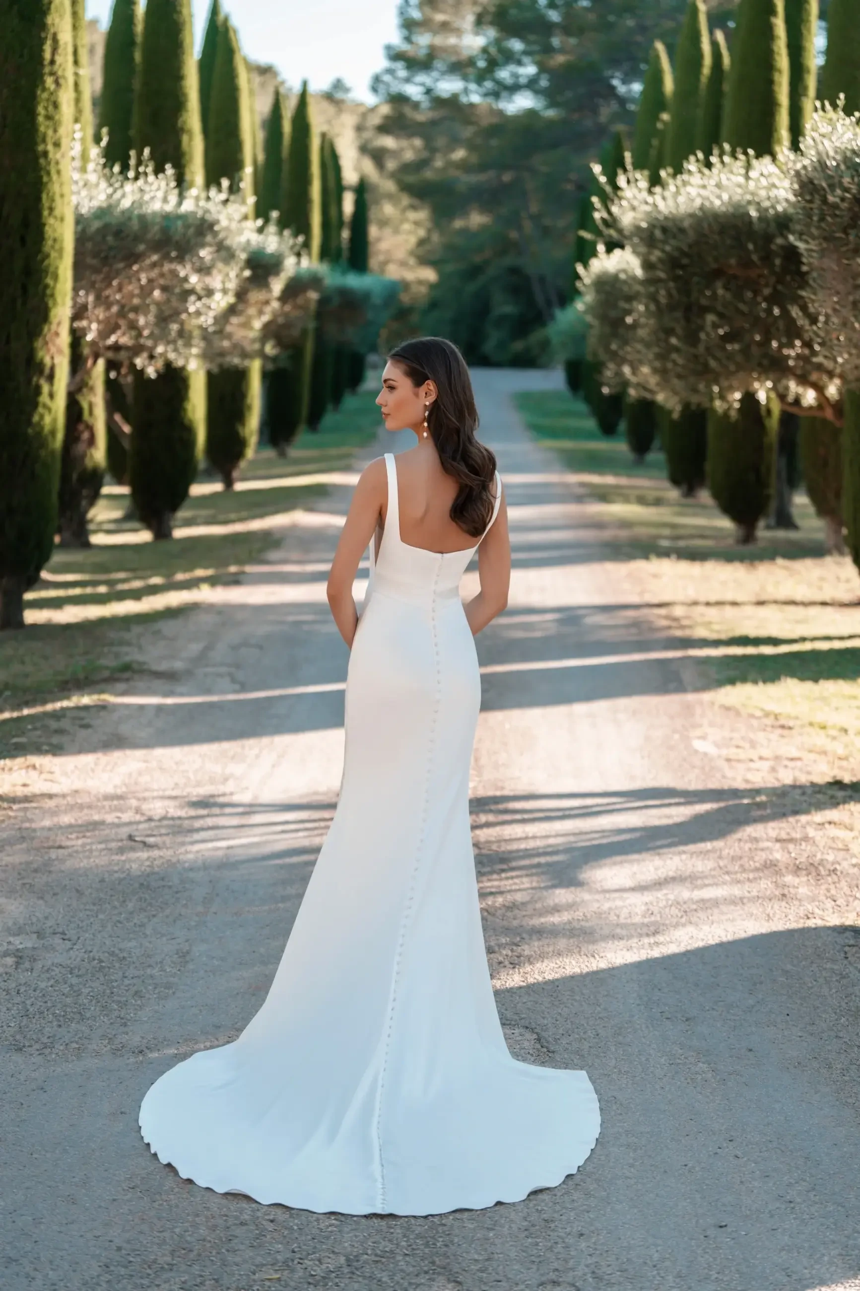 model is wearing a sleeveless square neckline wedding dress by allure bridals