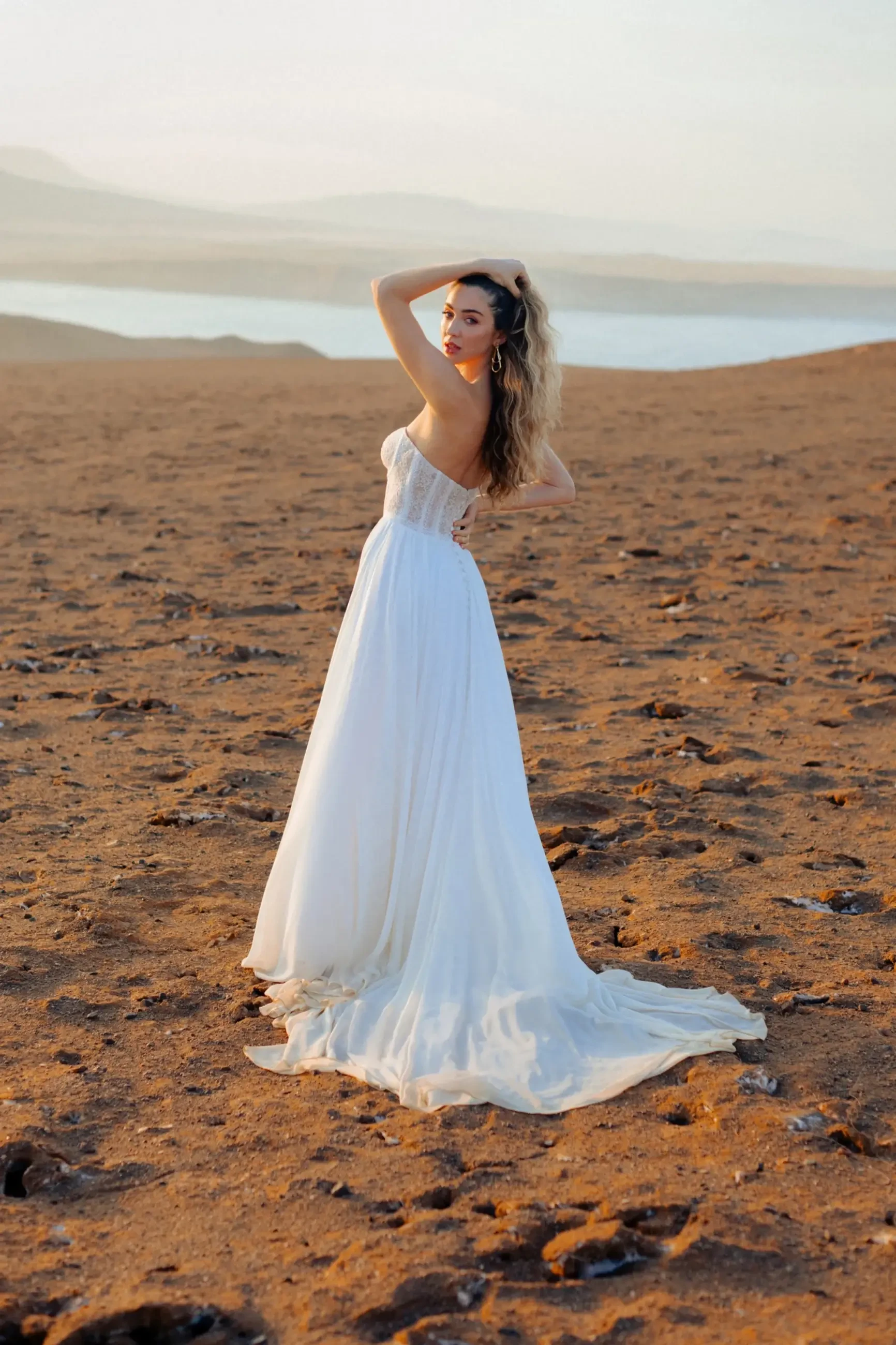 Model is wearing an A-line gown with a strapless sweetheart corded lace bodice and flowing chiffon skirt